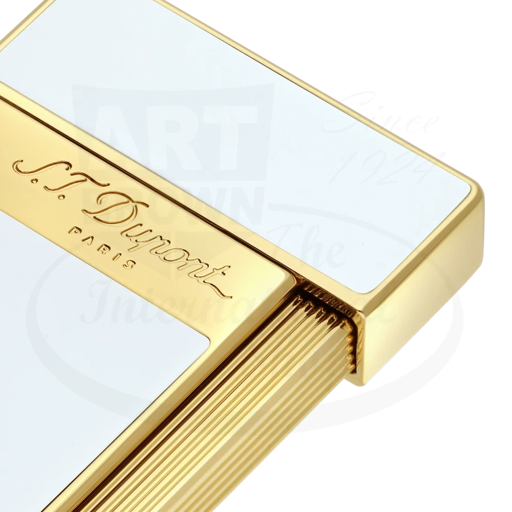 Corner of S.T. Dupont slimmy torch lighter with white lacquer and gold accents 