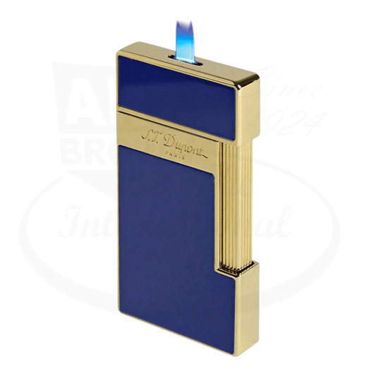 S.T. Dupont slimmy torch lighter with blue lacquer and gold finish seen from the side with flame lit