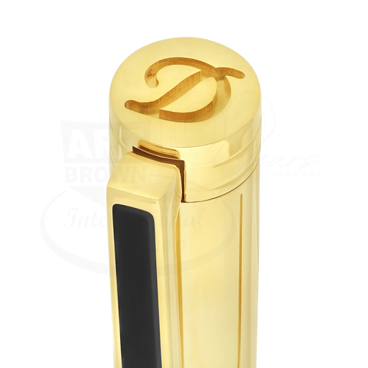 Close-up of a luxury gold and black lacquer pen cap with an engraved decorative letter D on top