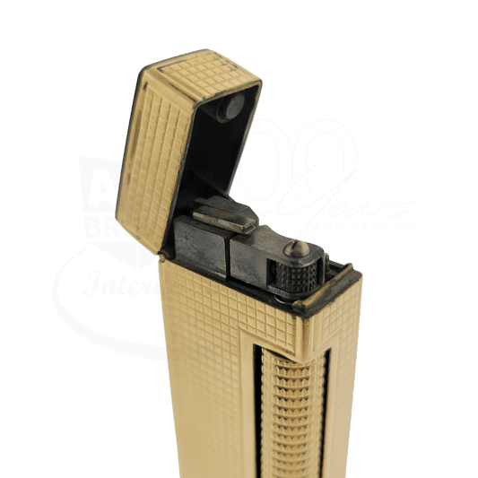 Vintage gold-tone lighter with hobnail textured pattern and open flip-top design revealing ignition wheel mechanism