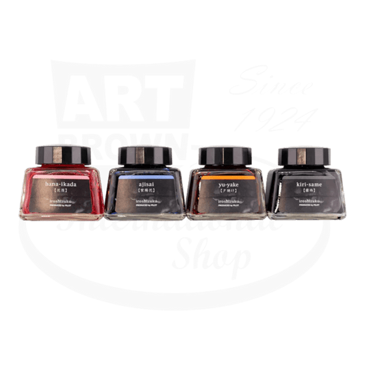 Pilot Iroshizuku Yu-Gure glass ink set featuring pink, blue, orange, and gray 30ml bottles with black caps in sunset collection packaging