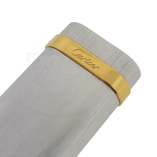 Cartier Duotone brushed pattern soft flame lighter Cartier-4 with gold-tone band and silver brushed metal body close-up