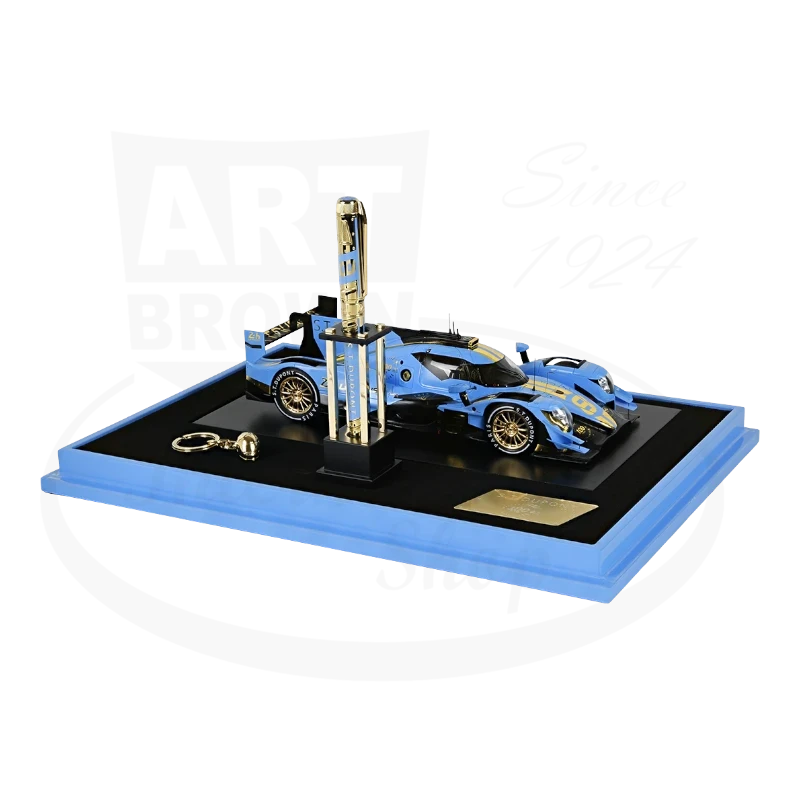S.T. Dupont Le Mans 420006XL gold-plated fountain pen with blue lacquer finish, displayed with matching die-cast race car on black and blue presentation stand
