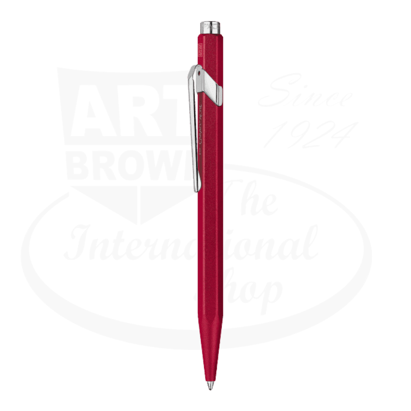 Caran D'Ache 849 Colormat-X ballpoint pen featuring a hexagonal metallic red body with chrome clip and push button, showcasing Swiss precision design