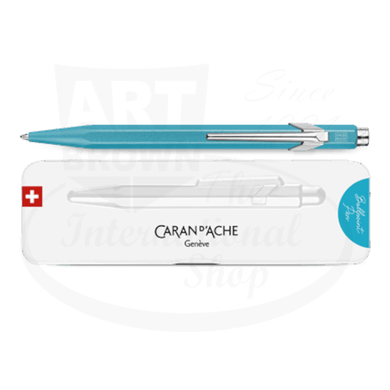 Caran D'Ache 849 Colormat-X turquoise metal ballpoint pen with hexagonal body and silver clip, shown with white branded case featuring Swiss flag