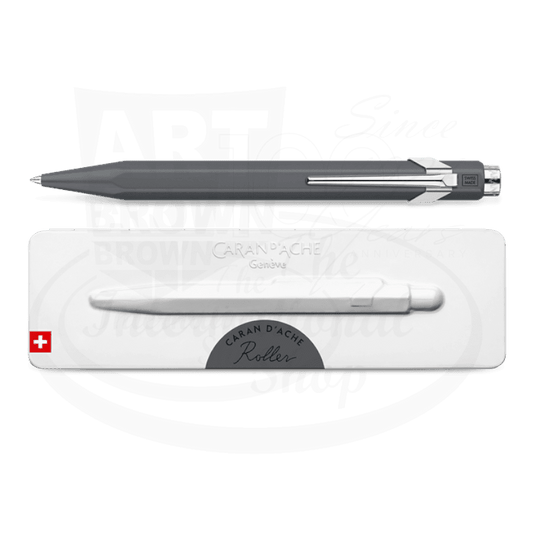 Sleek grey metal rollerball pen with chrome accents resting above a white slimpack box on branded background.