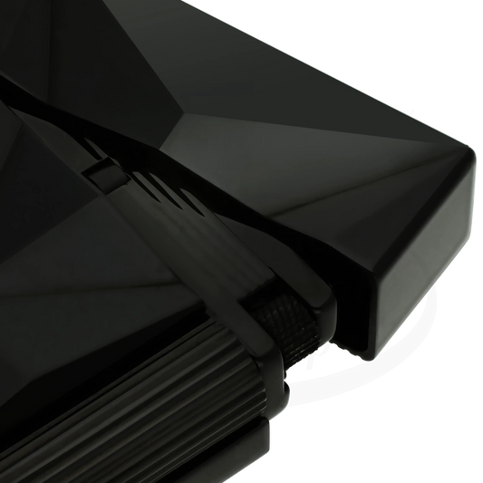 Close-up of S.T. Dupont Ligne 2 Fire X lighter in black showing the faceted pattern and mechanism.