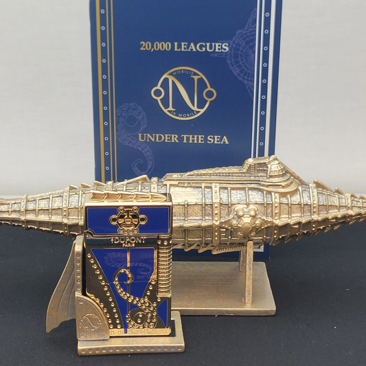 Gold and blue luxury lighter with submarine design and nautical theme display in the background