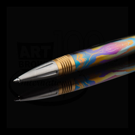 Close-up of a colorful luxury ballpoint pen with intricate lacquer and metal accents on a reflective black surface