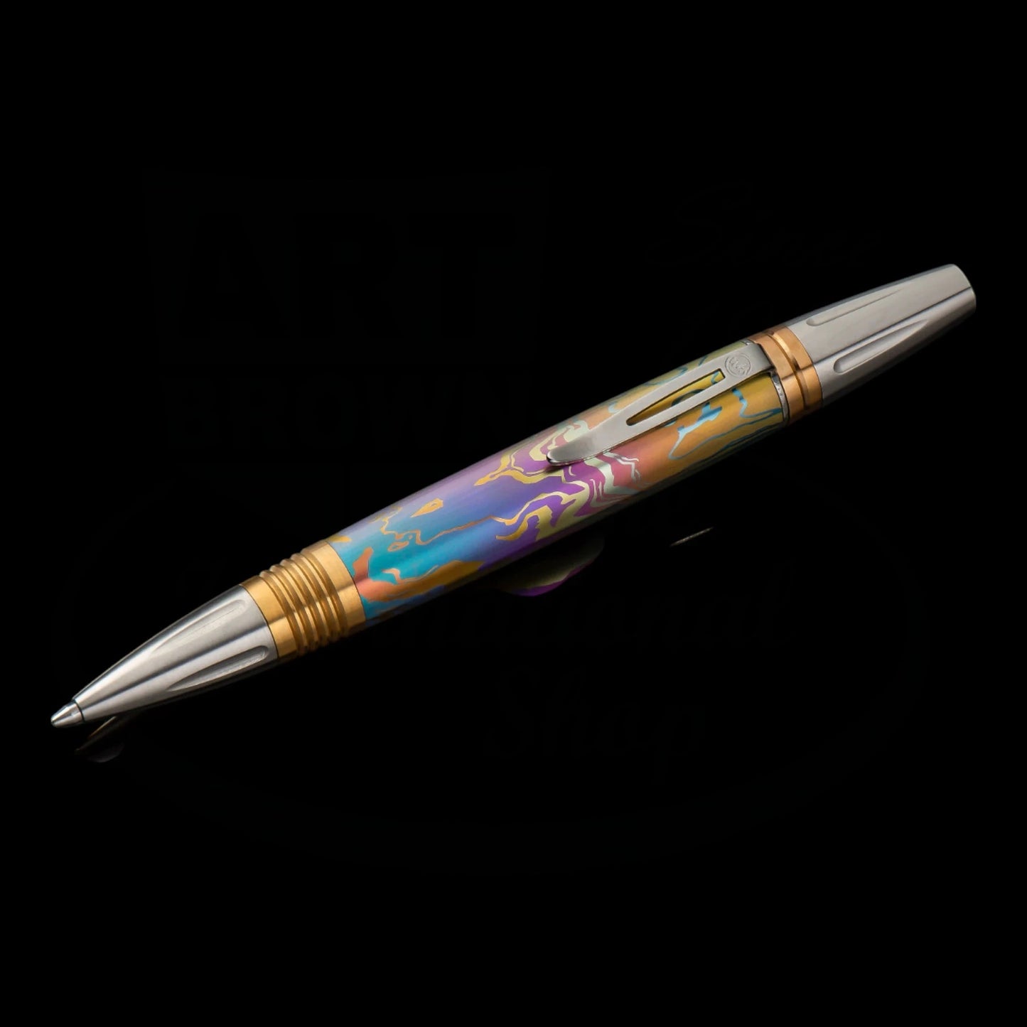 William Henry Caribe 8 titanium ballpoint pen with iridescent patterned barrel, brass accents, and stainless steel trim featuring art deco details