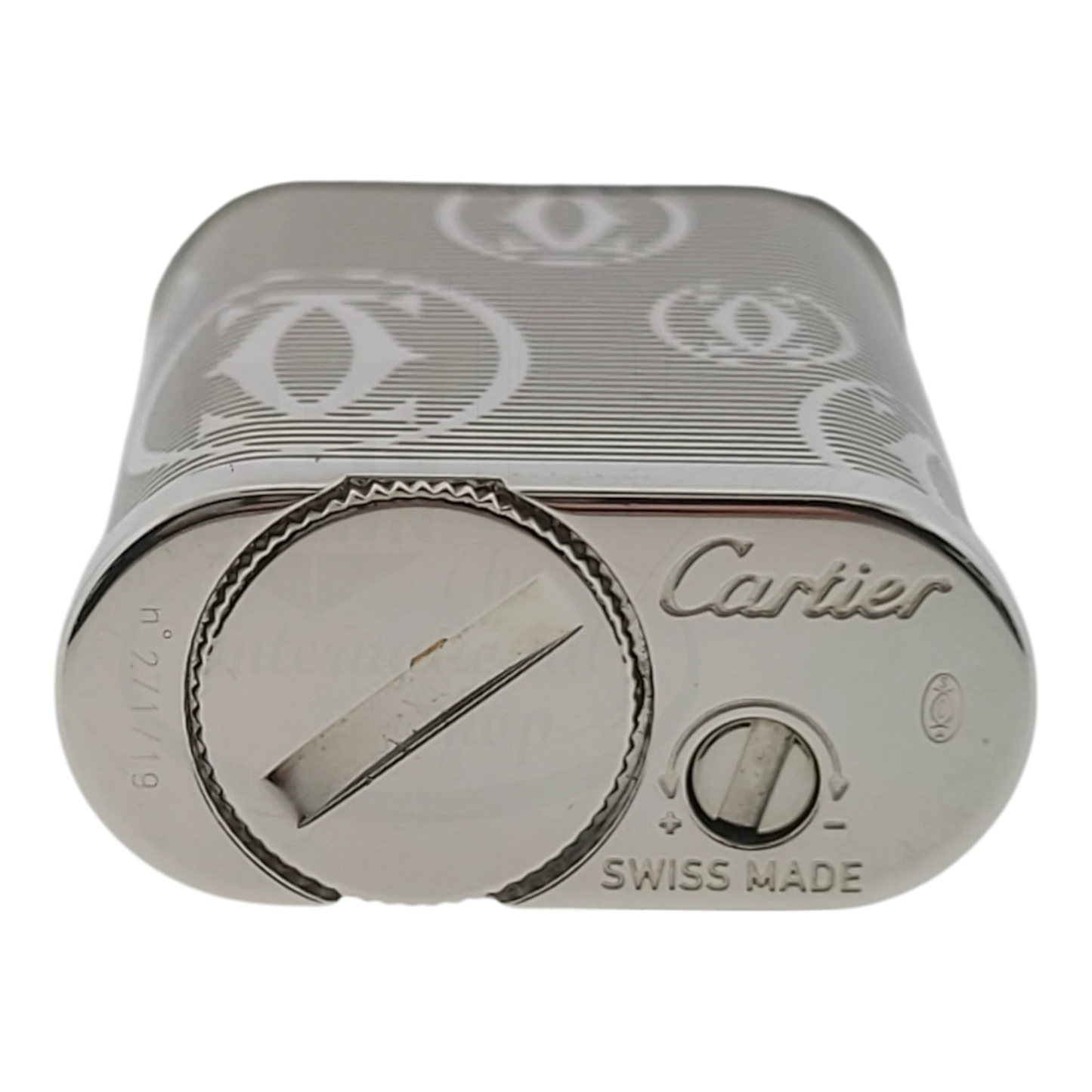 Cartier Pasha lighter with chrome body, horizontal lines, Cartier logo, and Swiss made soft flame mechanism close-up view
