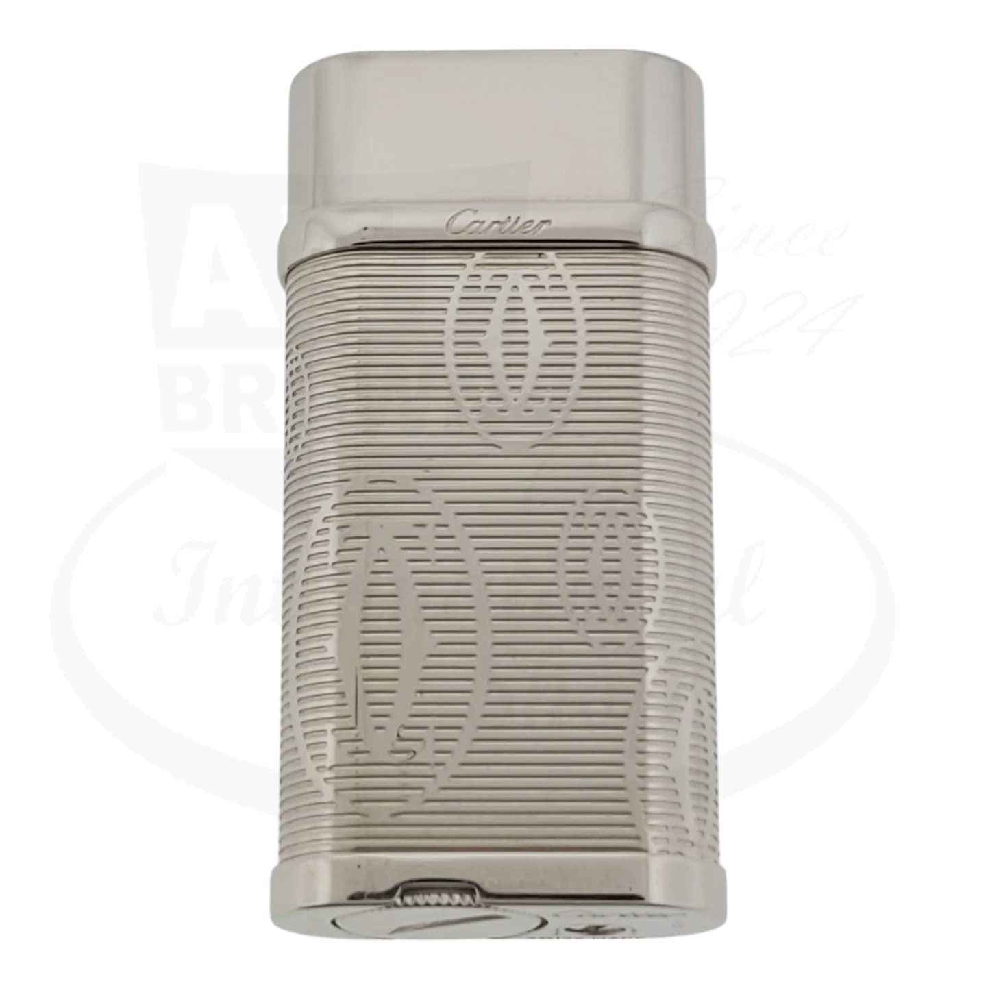 Cartier Pasha chrome lighter with horizontal etched lines and double C logo pattern on metal body with protective flip cap
