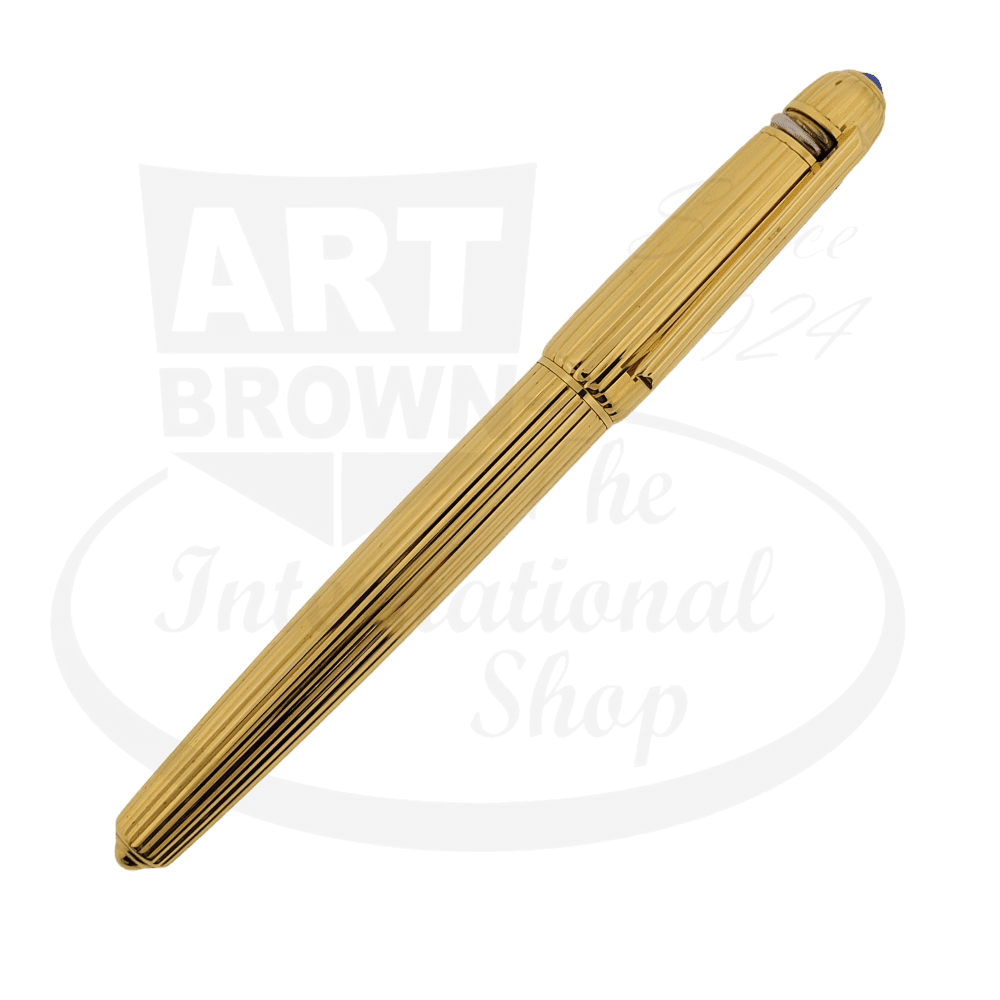 Cartier Pasha gold-plated fountain pen with ribbed barrel design, sapphire-accented tip, and 18K fine point nib in classic cylindrical shape