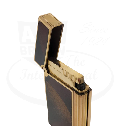 S.T. Dupont D-Line vintage lighter in orange lacquer with gold dust finish and brass construction, open lid showing gold-tone ignition mechanism