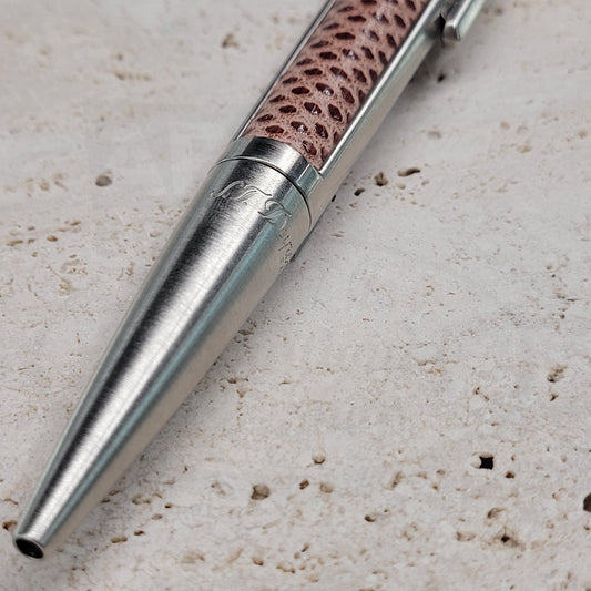 S.T. Dupont Defi ballpoint pen with red reptile leather barrel and chrome metal finish, featuring sleek design and textured exotic leather grip