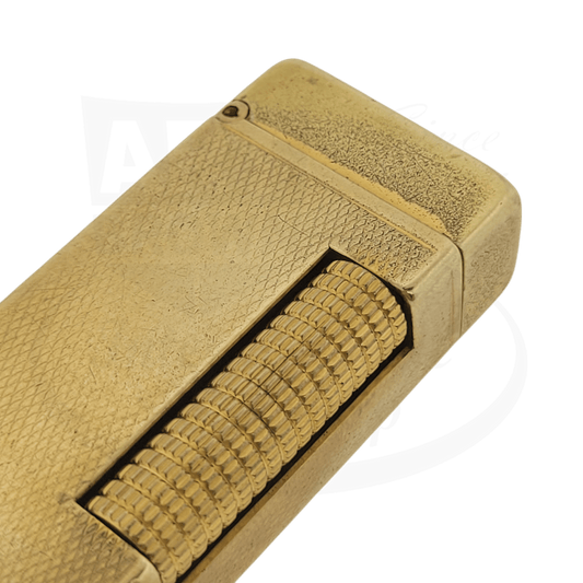 Close up of corner of Gold plated Dunhill Anomalies lighter with Barley grain pattern, with scratches from use.