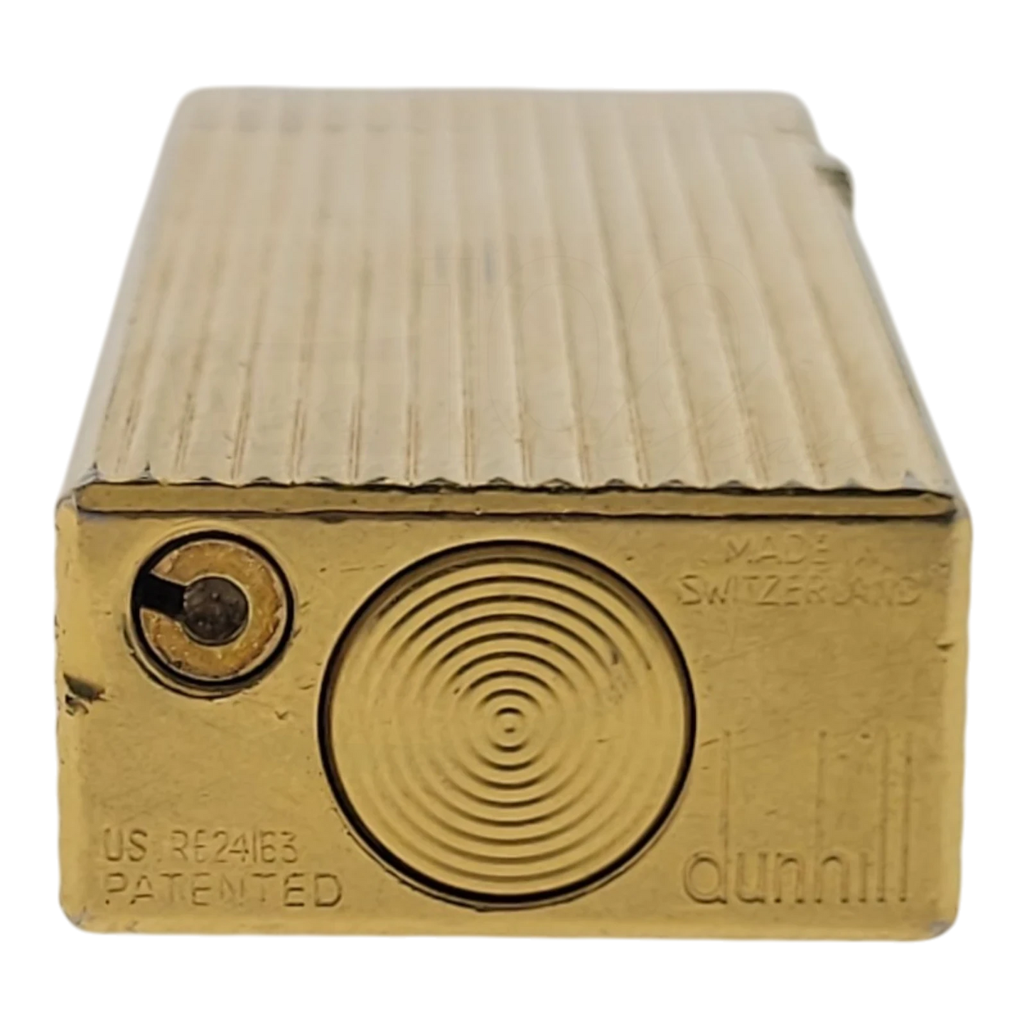 Dunhill Rollagas gold lighter with vertical lined pattern, soft flame, embossed logo, and textured ignition wheel