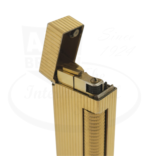 Gold plated Dunhill rollagas lighter with vertical lines pattern, with lid opened showing.