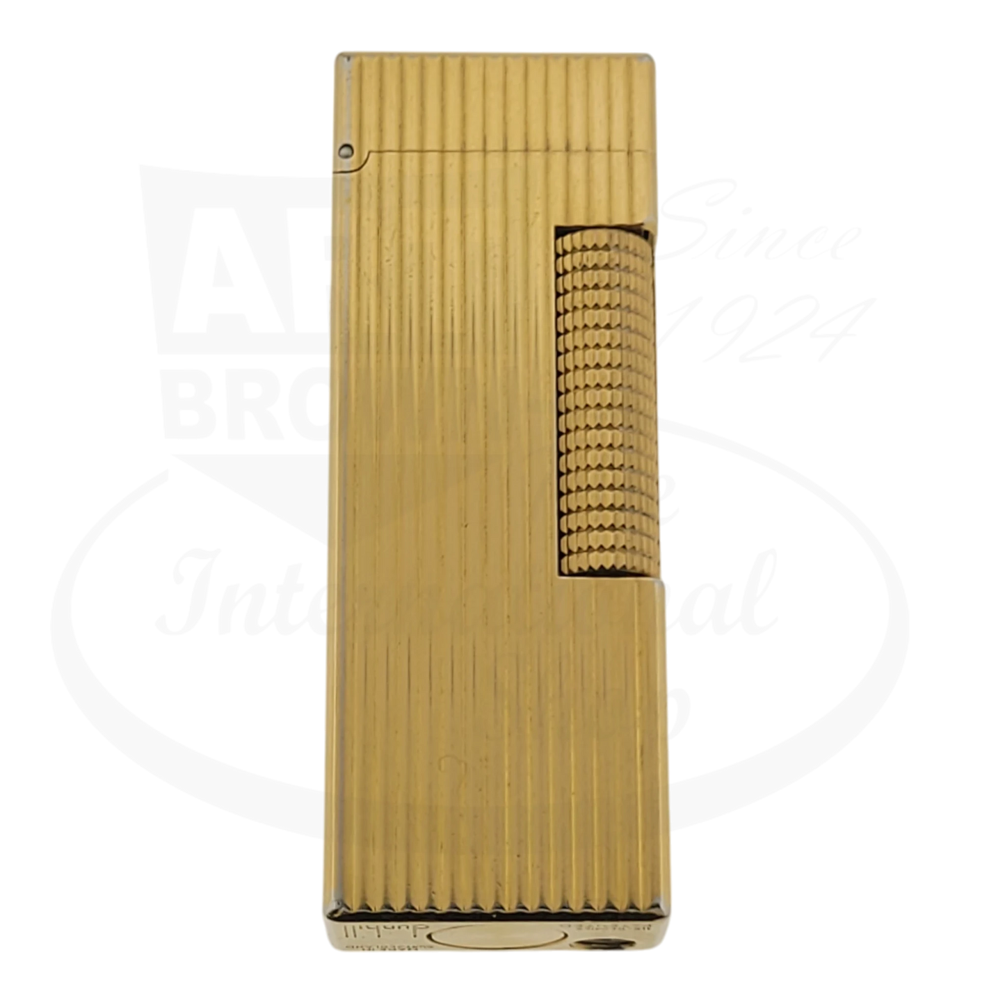 Gold plated Dunhill rollagas lighter with vertical lines pattern, seen from the front.
