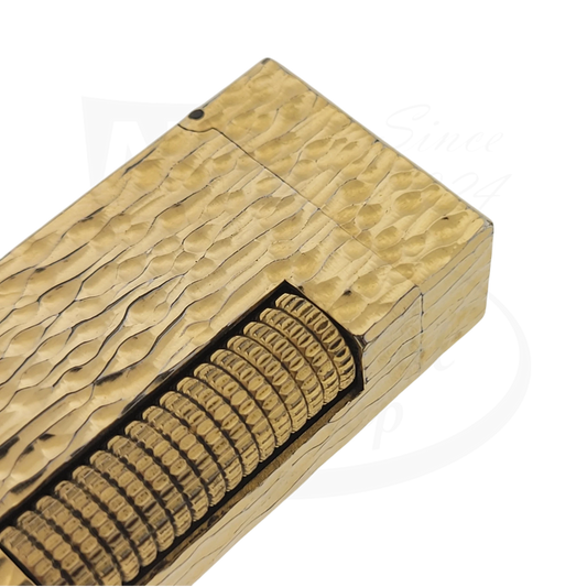 Close up of details on Gold plated Dunhill rollagas lighter with bark pattern.