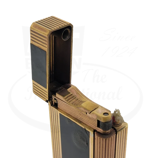 S.T. Dupont Ligne 1 vintage petrol lighter in black lacquer with gold-plated brass ridged design, open position showing flint wheel mechanism