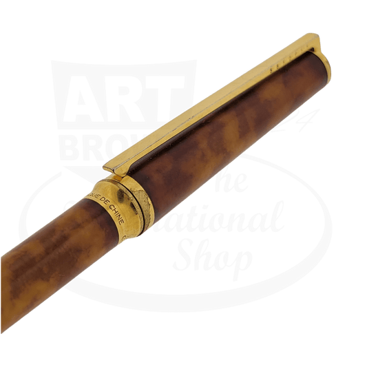 ST Dupont Classique ballpoint pen featuring orange tortoise shell lacquer barrel, gold-plated trim and clip, vintage condition showing wear details