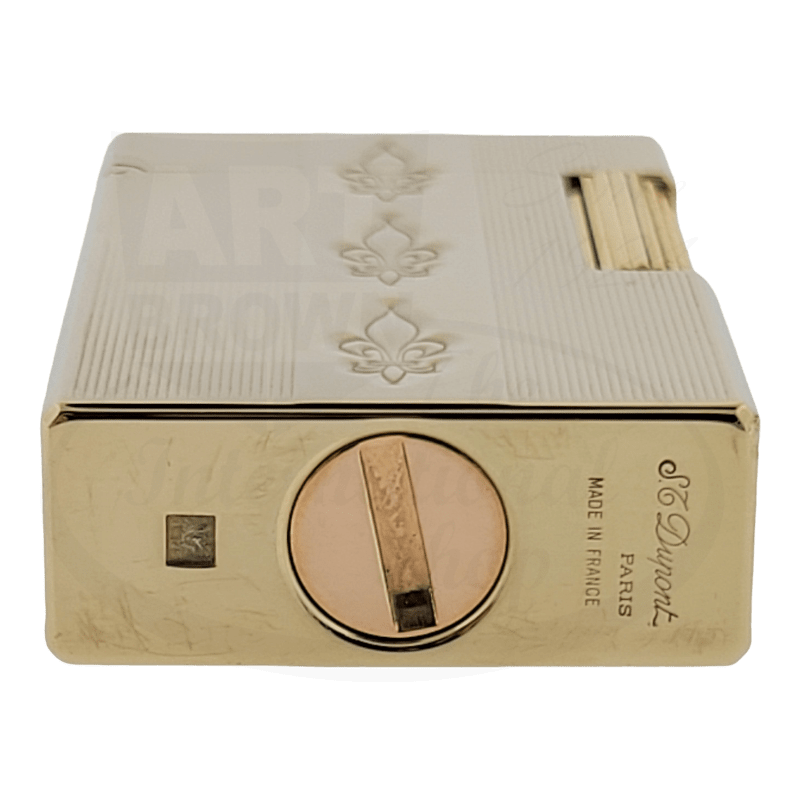 S.T. Dupont Ligne 1 brass-gold petrol lighter with fleur-de-lis pattern, rectangular shape, featuring circular ignition wheel and vintage patina