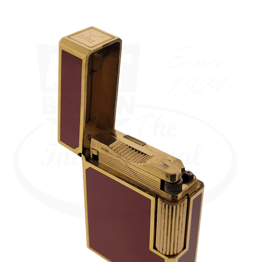 S.T. Dupont Line 1 vintage lighter in red lacquer and brushed gold finish, featuring engraved K monogram, open lid showing flint mechanism