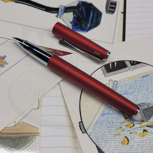 Lamy studio royal red matte finish rollerball pen with cap off, showing chrome grip.