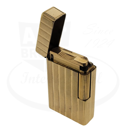 S.T. Dupont Ligne 1 BR 014339 gold-plated brass lighter featuring vertical line pattern, opened lid displaying flint mechanism, vintage condition