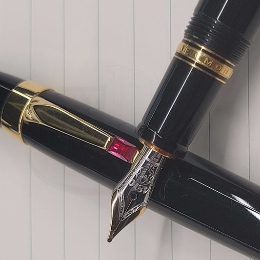 Montblanc Boheme Ruby fountain pen with 14K gold nib, black resin barrel, gold trim, and red jewel clip detail