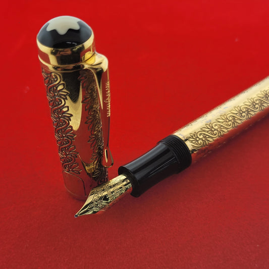 Montblanc Patron of Arts King Louis XIV fountain pen with 18K gold nib and engraved vermeil barrel and cap on red background