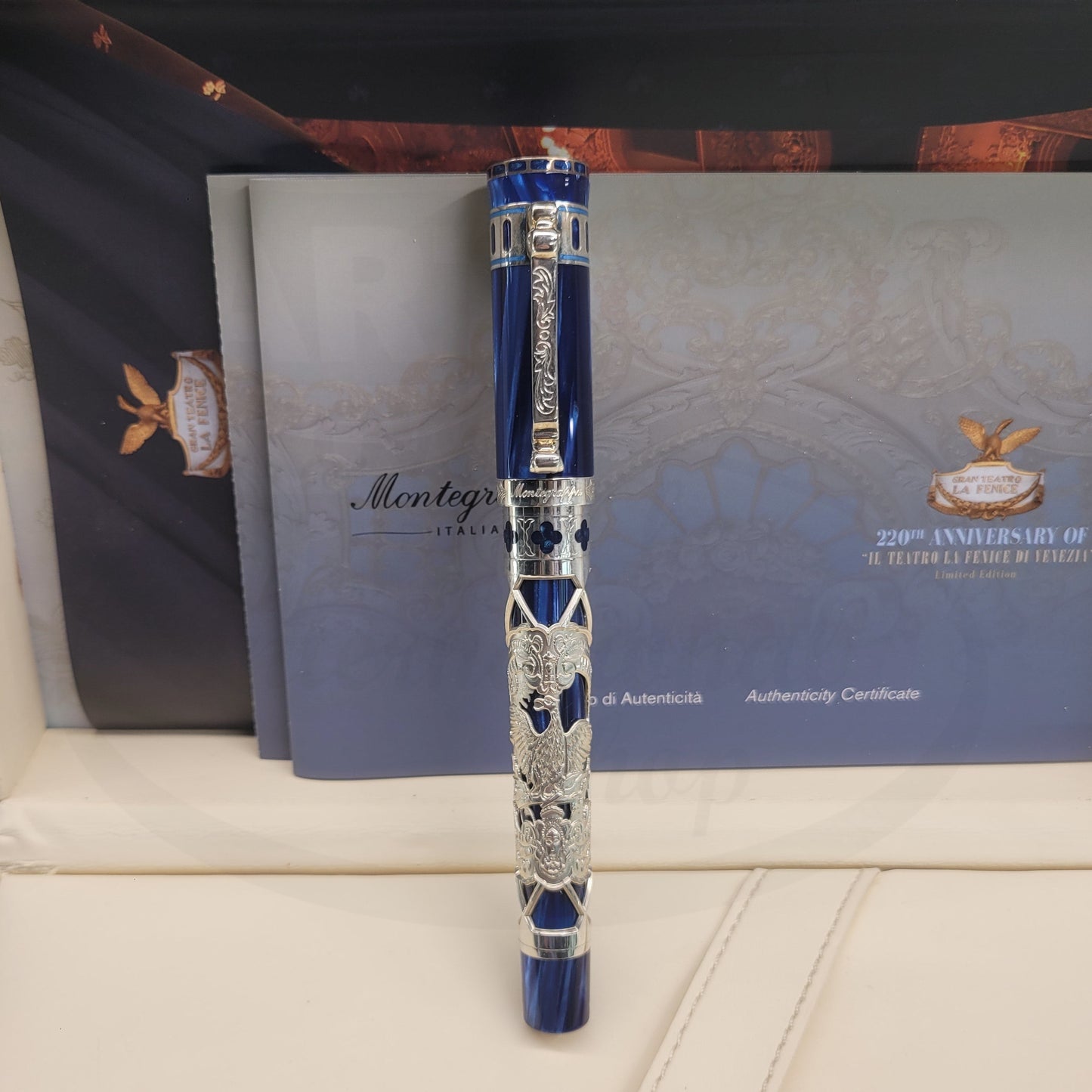 Montegrappa La Fenice ISTFNRSB rollerball pen in blue resin with sterling silver filigree overlay featuring theatrical motifs