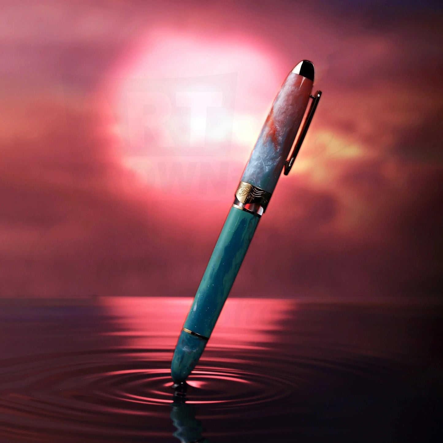 Nahvalur Horizon Dawn fountain pen in turquoise and orange resin with rose gold trim, floating on reflective surface at sunset