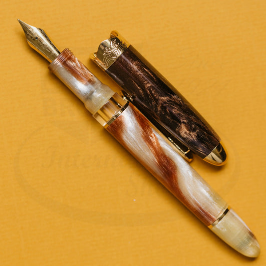 Nahvalur Horizon Desert fountain pen in pearlescent desert-toned resin with gold trim and transparent ink window, cap removed