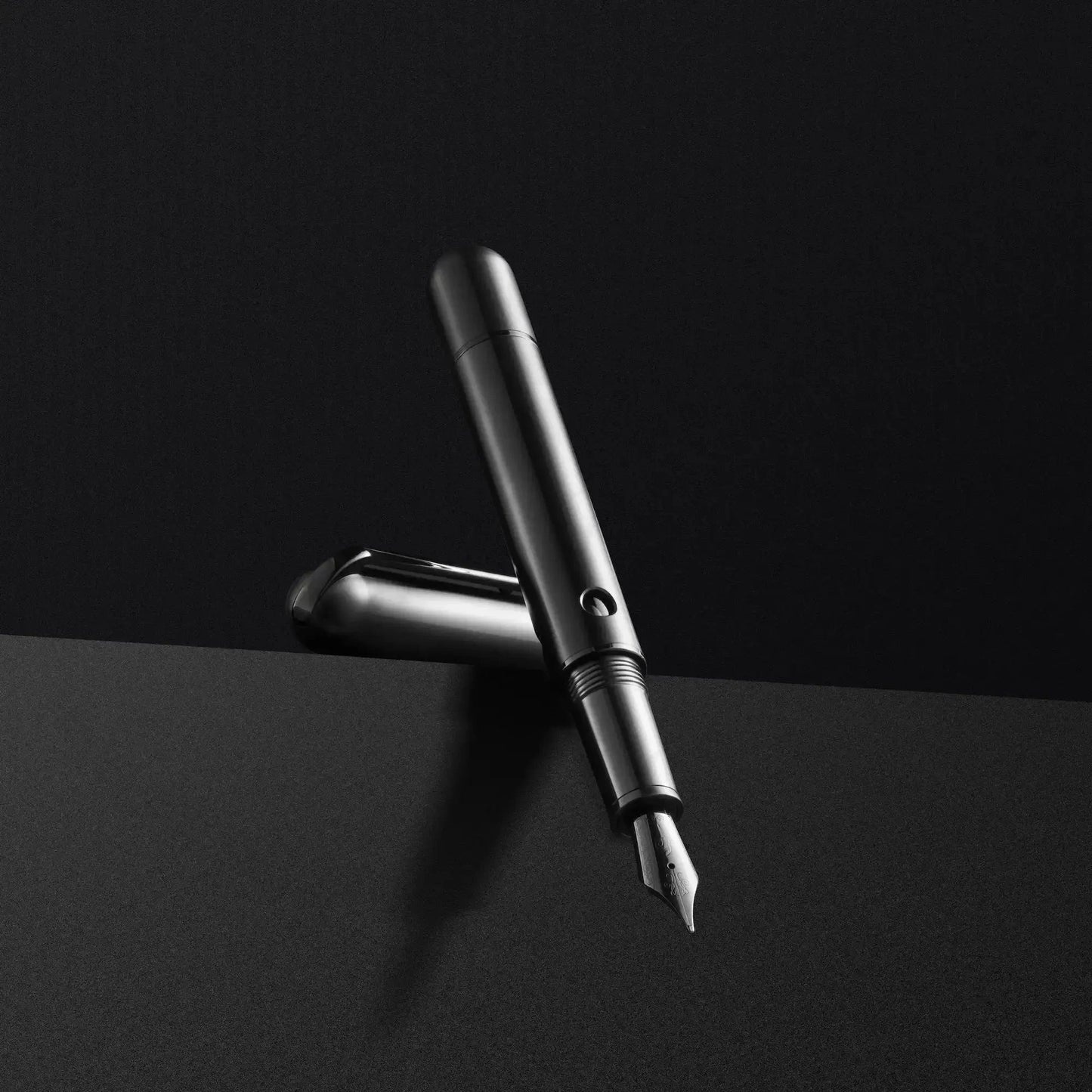 Nahvalur Nautilus Ti Black medium fountain pen in anodized titanium with piston-fill system and porthole ink windows