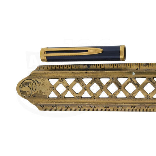 Waterman pen cap in deep blue lacquer with a polished gold clip and gold band detailing, shown beside a brass ruler