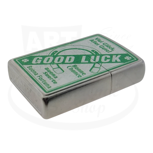 Brushed Chrome windproof lighter with a green 'Good Luck' design, featuring a horseshoe and multilingual greetings.