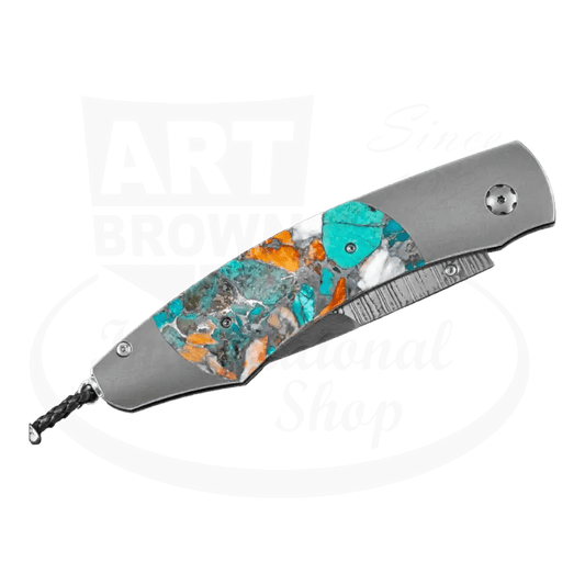 William Henry Spearpoint Ocean Breeze folding knife featuring titanium handle with turquoise and spiny oyster inlay, wave damascus steel blade, and blue topaz accents