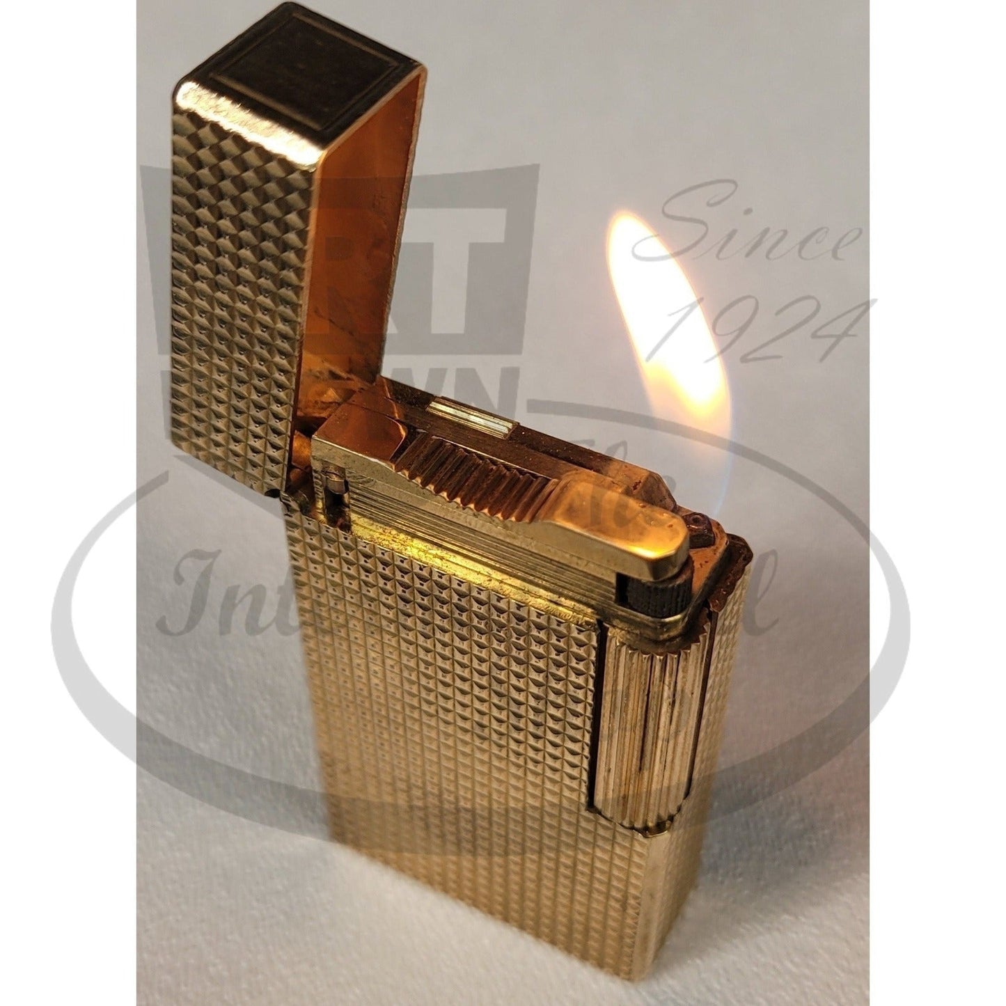 S.T. Dupont Vintage Line 1 Gold Diamond Head Lighter gold metal with textured surface open and lit flame