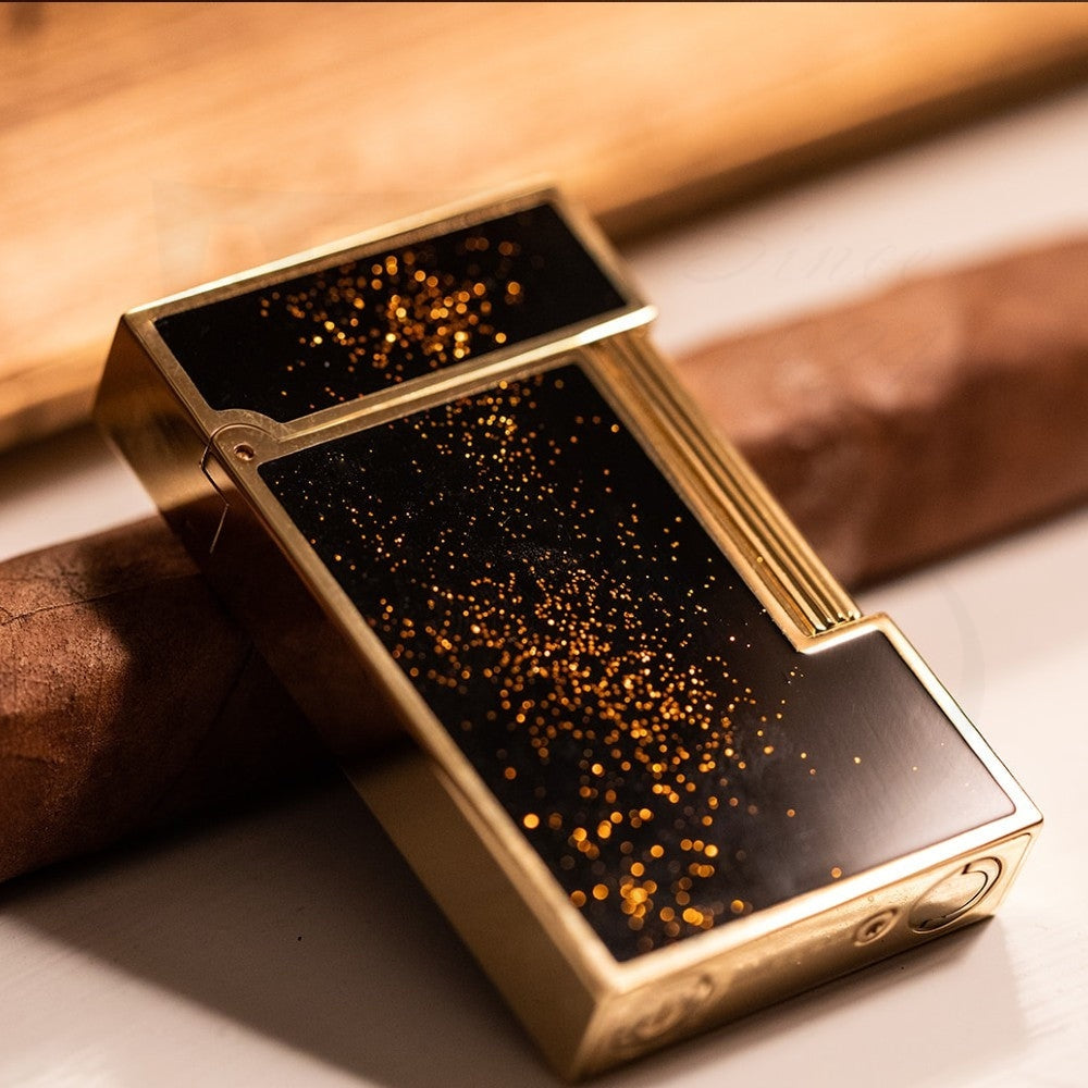 S.T. Dupont Ligne 2 Gold Dust C16882 brass lighter with black lacquer finish and gold dust sparkle pattern, featuring vertical ridged accents
