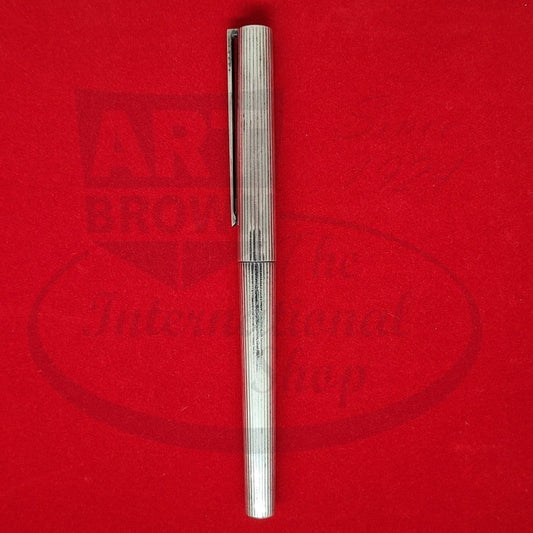 S.T. Dupont Classique Sterling Silver fountain pen with vertical line pattern, 18K gold medium nib, refurbished condition, displayed on red background