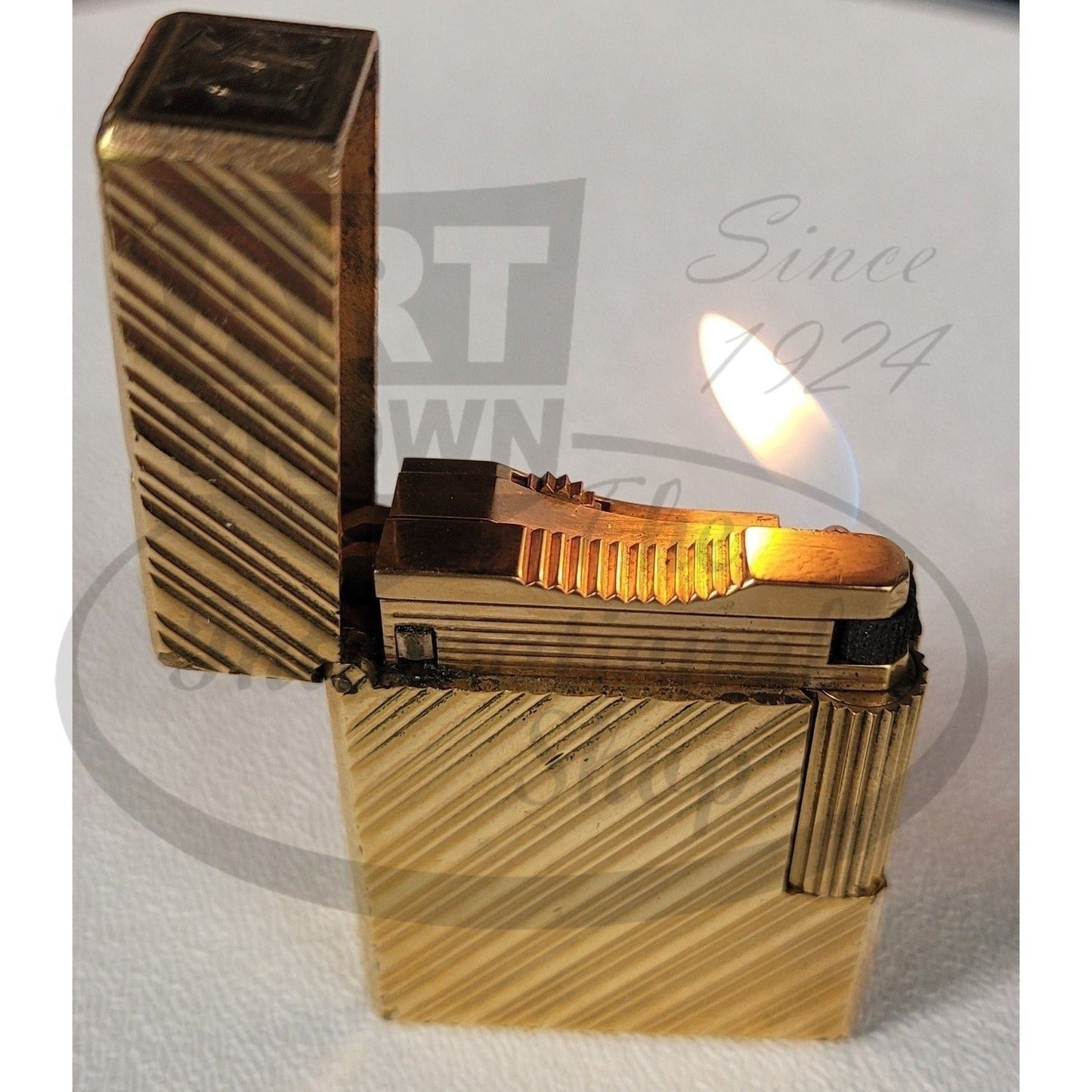 S.T. Dupont Vintage Line 1 Short Gold Lighter with Diagonal Line Pattern, gold metal finish, open flame visible