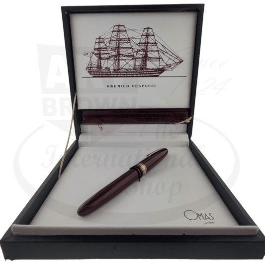 OMAS Amerigo Vespucci Briarwood fountain pen with gold-plated trim in luxury presentation box featuring ship illustration, displayed against white interior