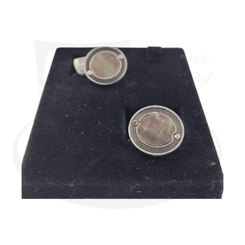 Stephen Webster sterling silver cufflinks featuring round black mother of pearl inlays on dark display cushion, showcasing elegant circular design with metallic rim detail