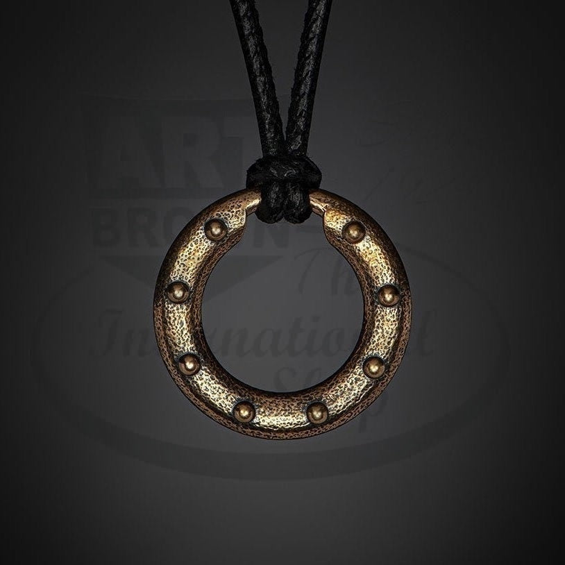 William Henry Bronze Orbit bronze pendant with rivet pattern on leather cord and bronze clasp