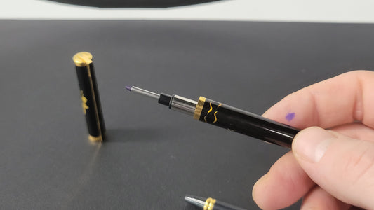 S.T. Dupont rollerball being refilled with S.T. Dupont rollerball ink cartridge