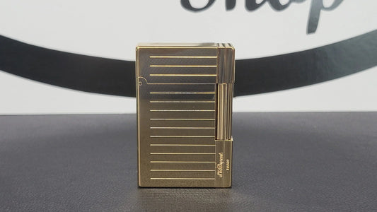 S.T. Dupont gatsby lighter with gold finish, seen from the front.