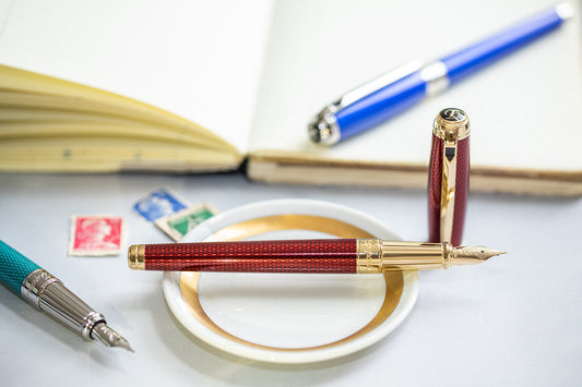 Variety of S.T. Dupont pens with different color lacquer and different finishing materials.
