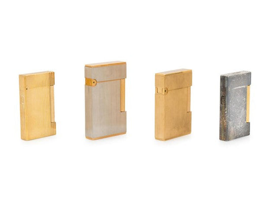 Various dirty vintage S.T. Dupont lighters on black background